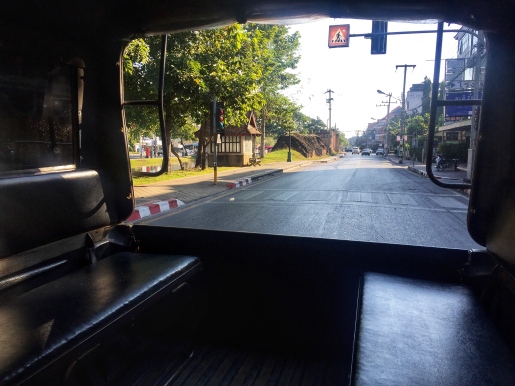 Sitting in the back of an empty songthaew